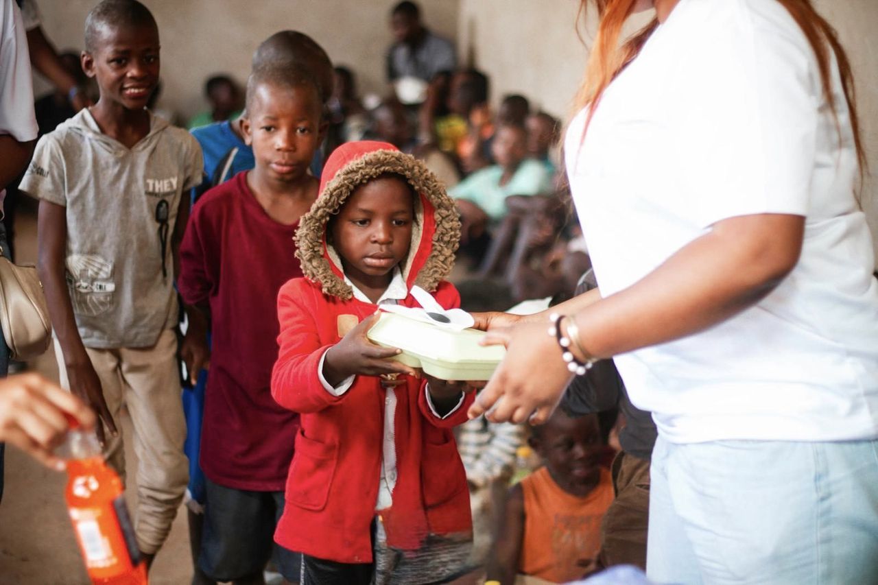 Children sharing a warm meal together through a feeding program in the DRC